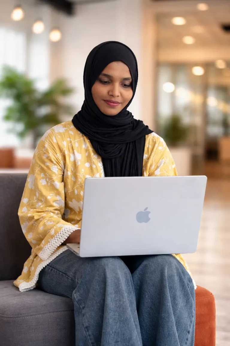 Freelance digital marketer working on a laptop in a modern office